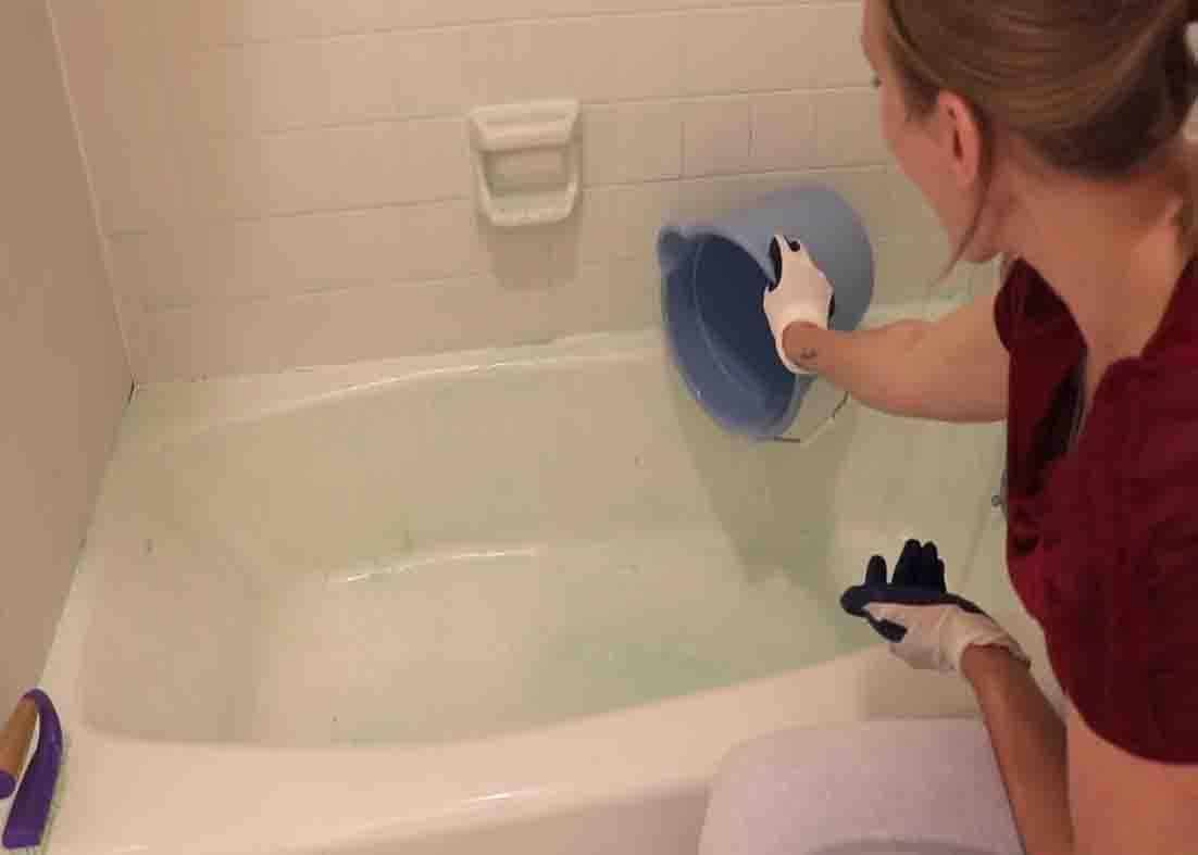 Pouring warm water all over the cleaned area on the shower
