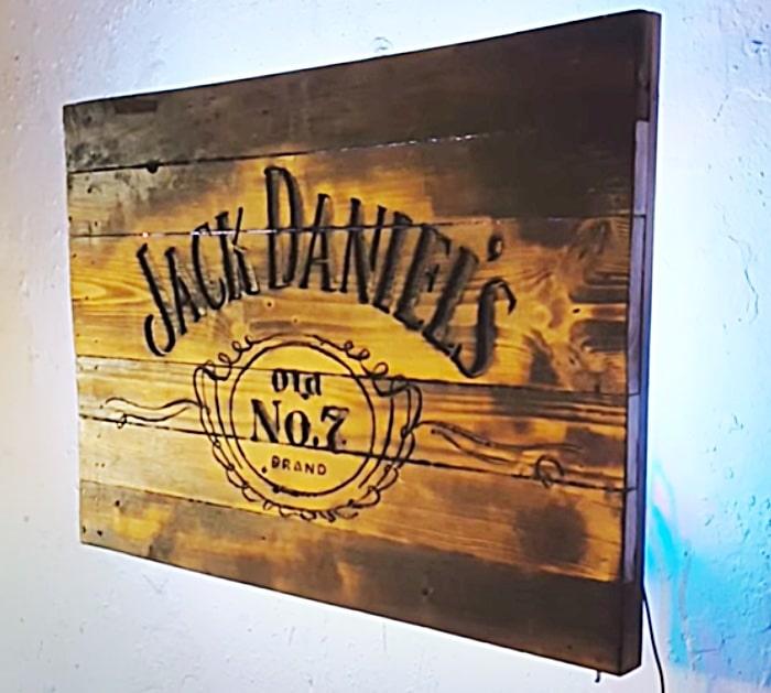 Jack Daniels logo carved and burnt into a DIY drinks cabinet and sign