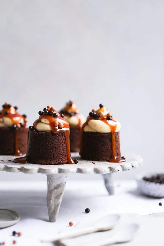 Earl Grey salted caramel brownies baked as small round cakes with buttercream swirls and caramel drizzle