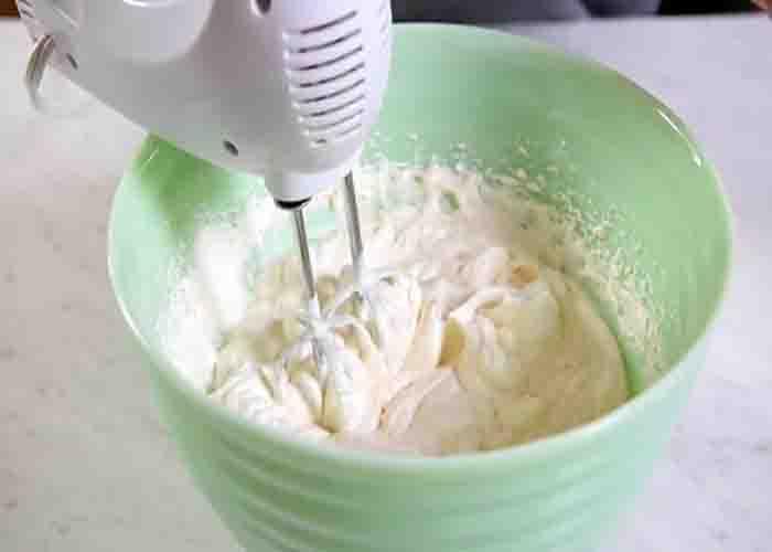 Whipping the cream for the cherry delight recipe
