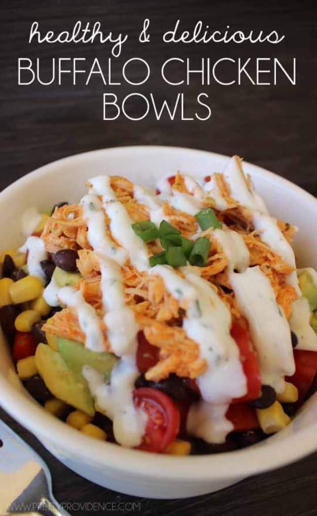 Healthy buffalo chicken bowl with corn, black beans, cherry tomatoes, avocado and shredded chicken with ranch