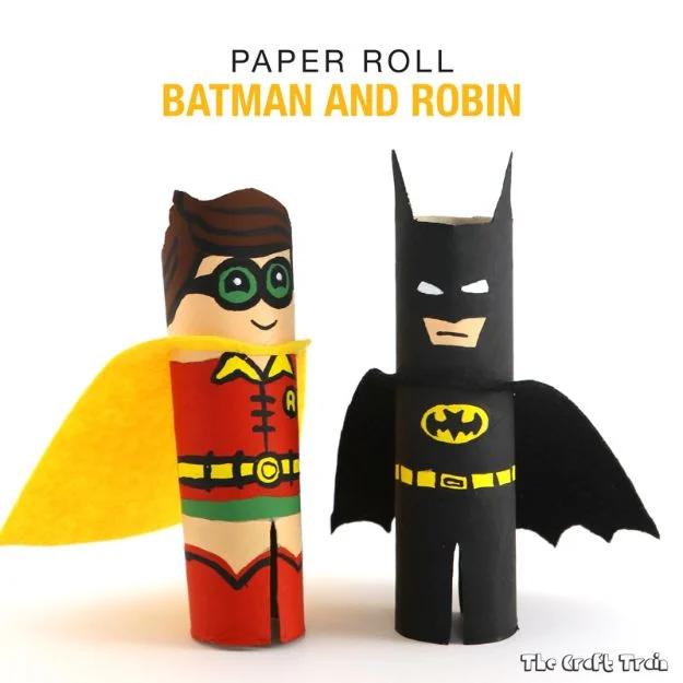 Batman and Robin made from painted paper towel rolls, Robin in a yellow felt cape and Batman in black
