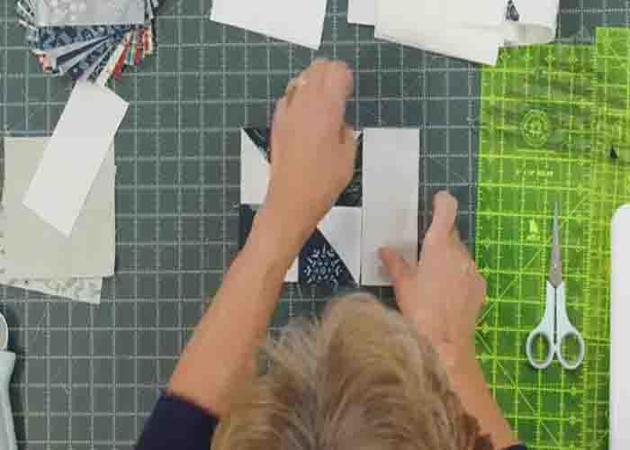 Adding the sashing on each pinwheel quilt block