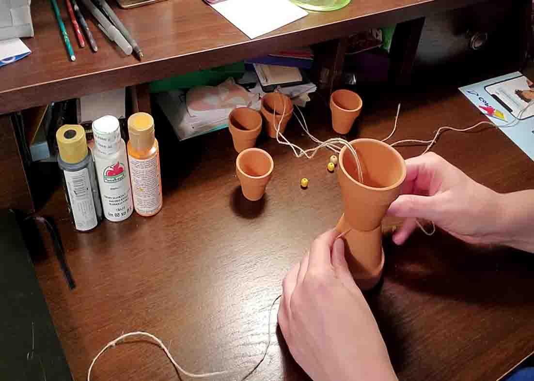 Assembling the body of the terracotta pot scarecrow