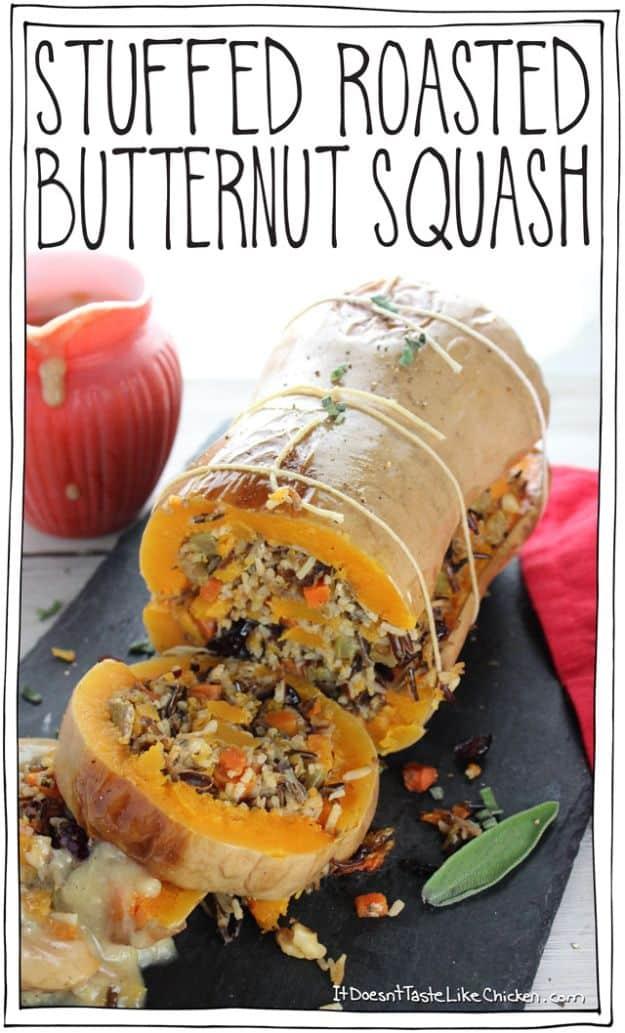 Stuffed roasted butternut squash tied with string and sliced open to show wild rice, cranberry and nut stuffing