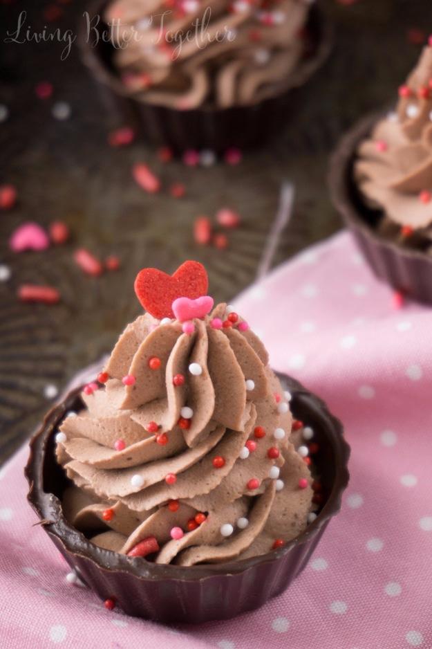 4 ingredient chocolate mousse piped into a dark chocolate cup with sprinkles, an easy no bake last minute dessert