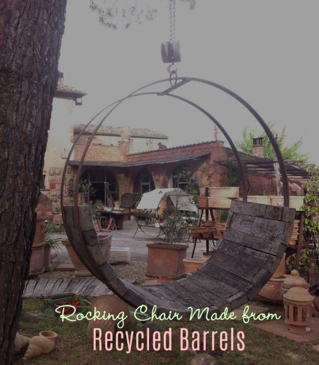Rocking chair made from recycled barrels, a seat built inside a large metal barrel hoop hung from a tree by chain
