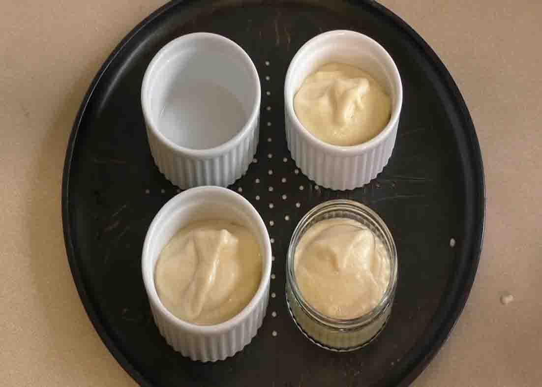Distributing the souffle mixture to the ramekins