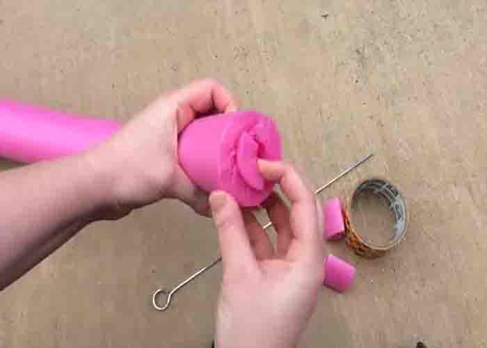 Poking holes to the pool noodle to make the sprinkler
