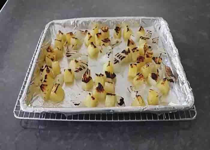 Broiling the pineapple, onion, and garlic to make the salsa