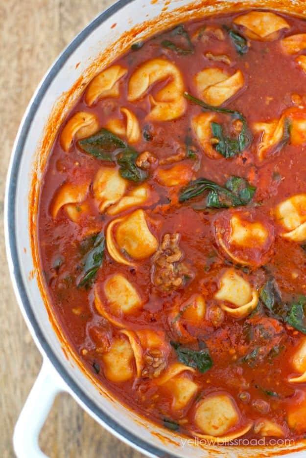 Sausage tortellini soup with spinach and cheese tortellini in a rich tomato broth topped with parmesan