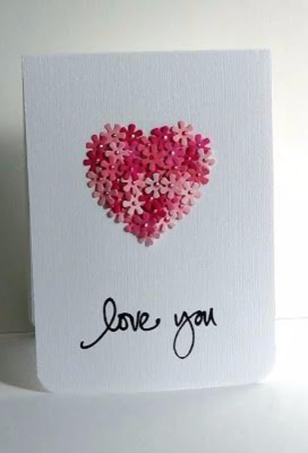 Love You card with a heart shape filled by about thirty small die cut paper flowers in pinks and reds