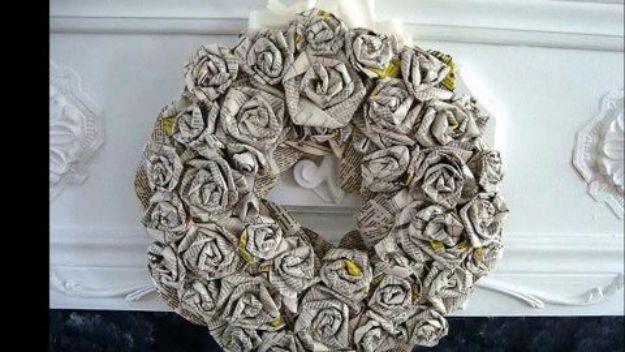 Paper roses wreath made from tightly rolled book page and newsprint roses hanging on a white painted mantel