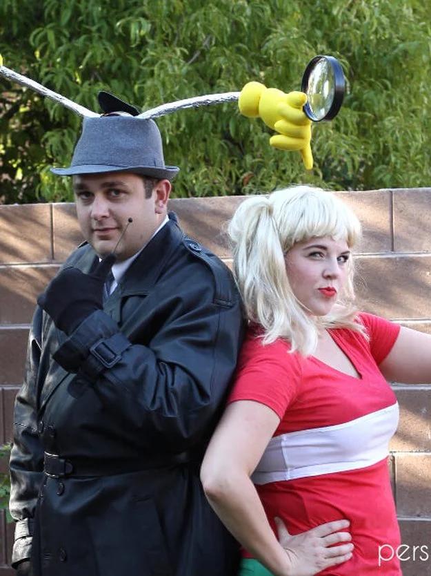 Two adults dressed as Inspector Gadget and Penny, with a trench coat, fedora, blonde wig, red shirt and gadget arms