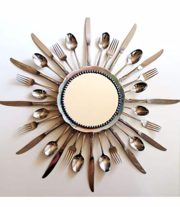 Starburst wall mirror of knives, forks and spoons radiating from a small round mirror with a beaded edge