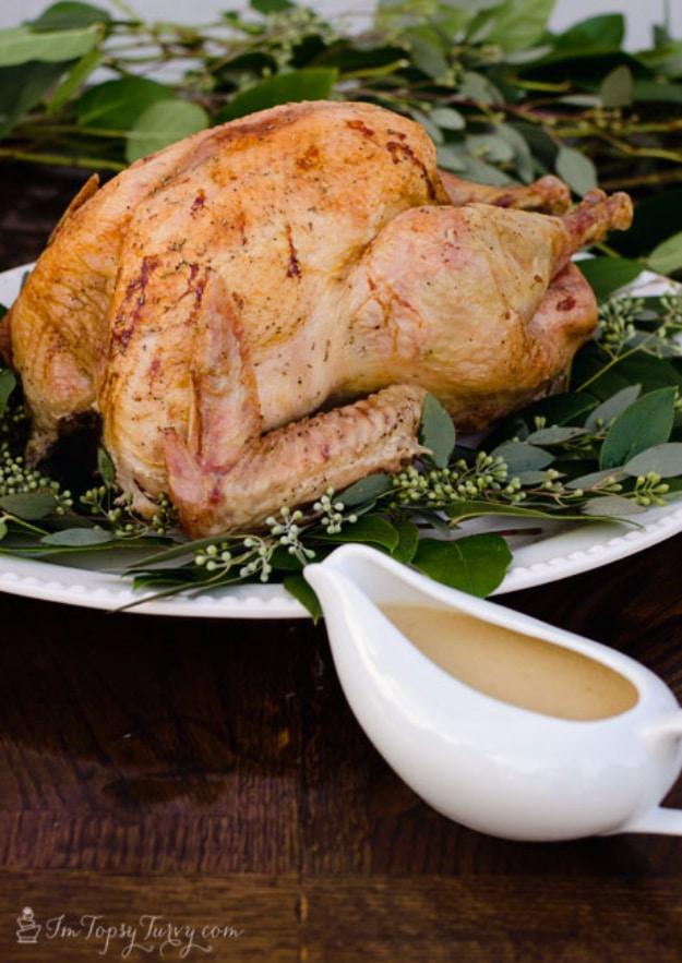 Brown bag turkey roasted inside paper bags, browned and juicy, resting in a pan with onions and garlic