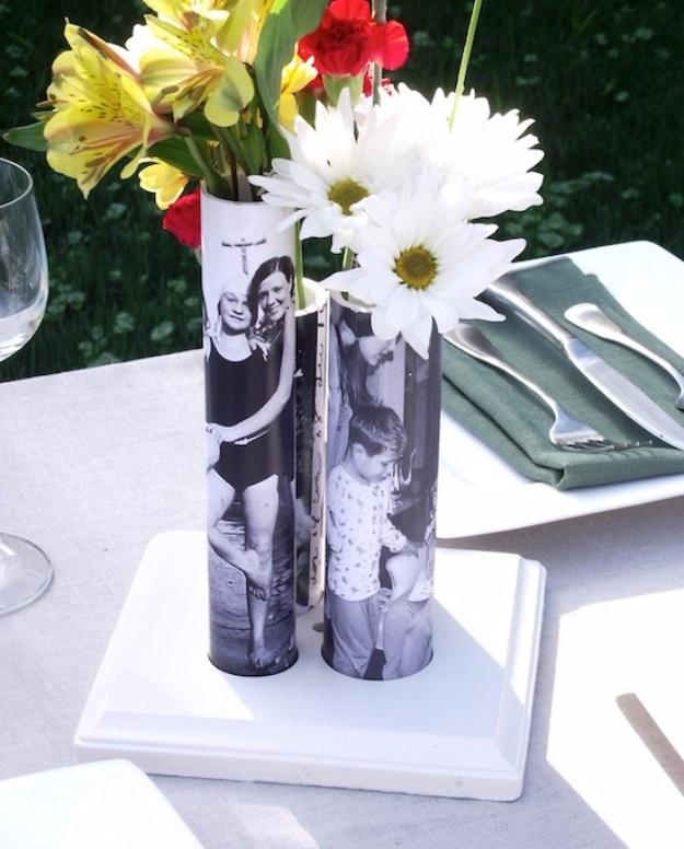 A short length of PVC pipe painted white with a photo pocket on the front, holding daisies on a shelf