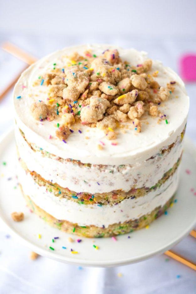 Momofuku style birthday layer cake with cream cheese buttercream and cake crumb between naked layers