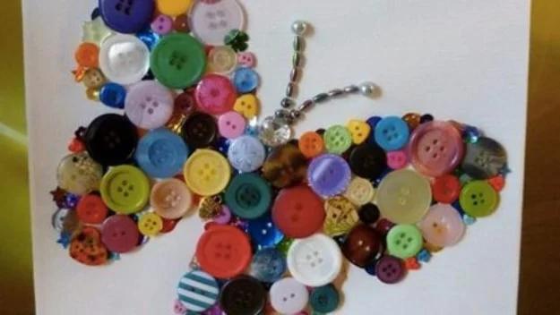 DIY button butterfly art, a butterfly shape filled with mixed coloured buttons and a beaded body on a white canvas