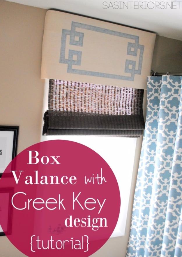Drop cloth box valance with a gray Greek key border over a woven shade and blue patterned curtains, with typeset text