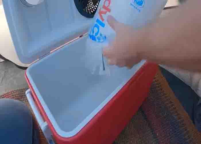 Adding ice into the DIY ice cooler
