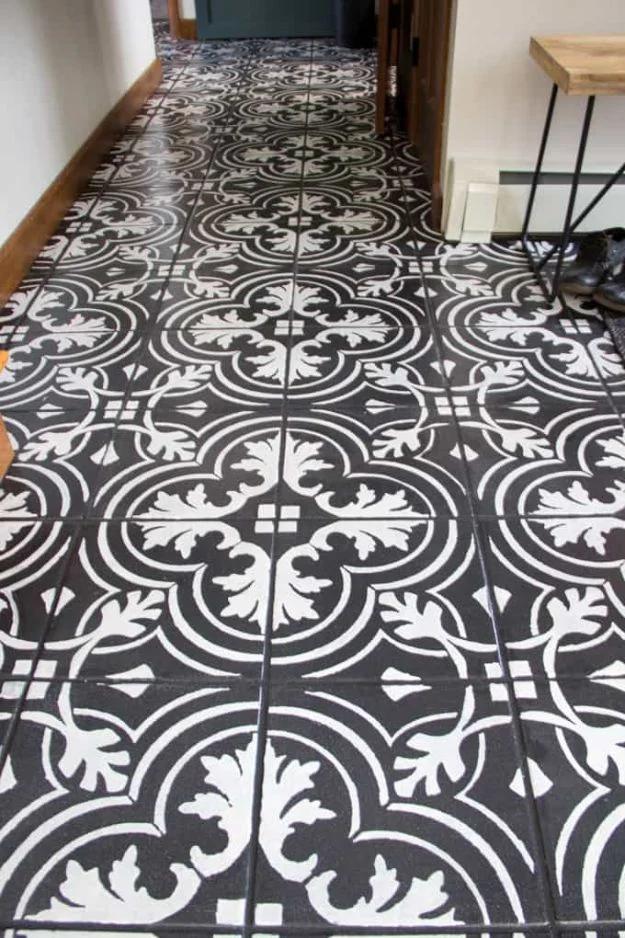 Faux cement tile painted floors, an ornate black and white stenciled tile pattern running down an entry hallway