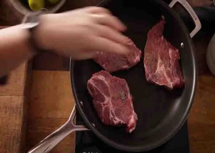 Frying the pork chops before slow cooking