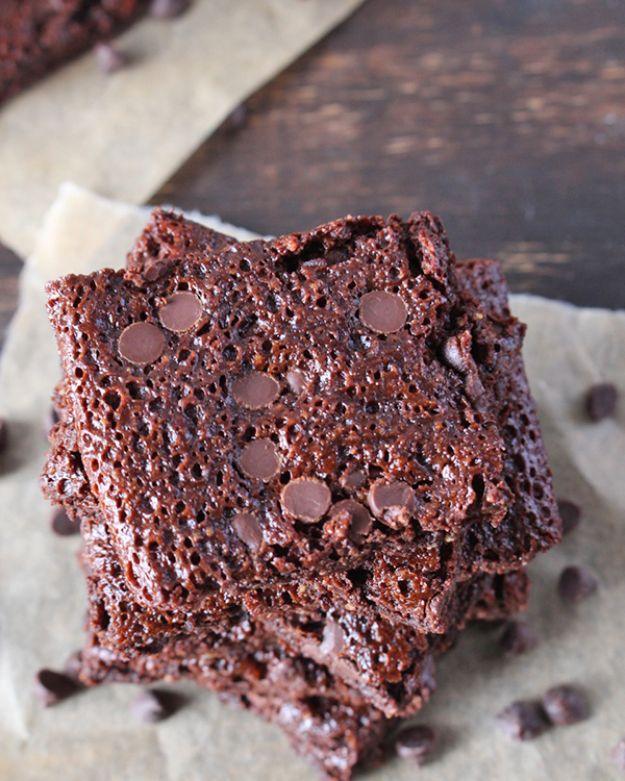 Easy paleo brownie brittle bark stacked in thin crisp shards studded with chocolate chips on parchment paper