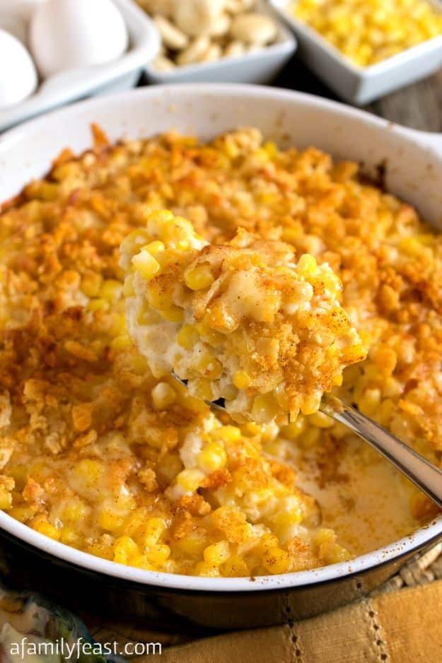 Nantucket corn pudding baked golden in a round dish with a crushed cracker and cheddar topping dusted with paprika