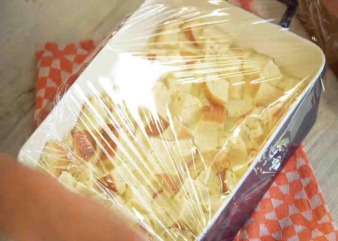 Covering the French toast casserole with plastic wrap
