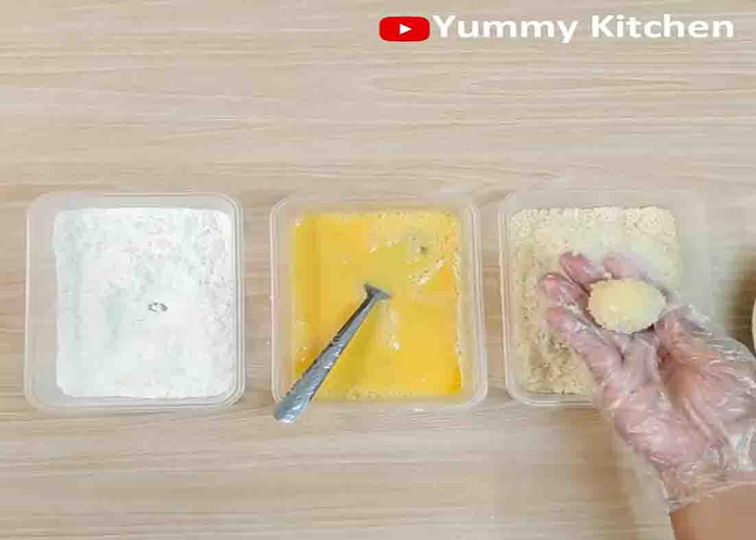 Dipping the potato balls to the flour, beaten eggs, and breadcrumbs.