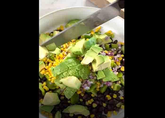 Assembling the black bean salad with cilantro lime dressing