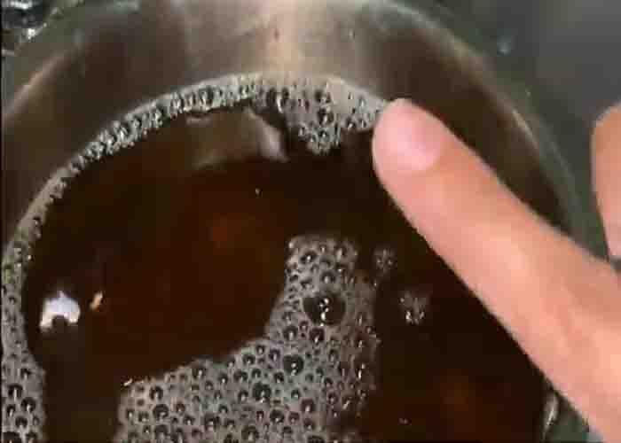 Filling the burnt pot with water