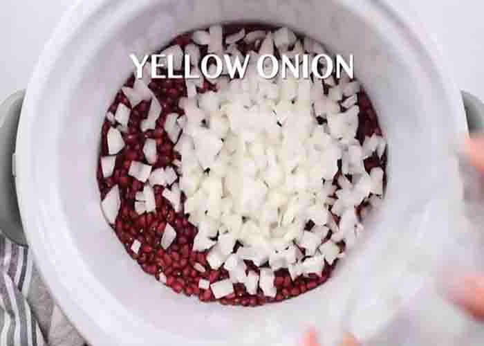 Adding the red beans ingredients in the slow cooker
