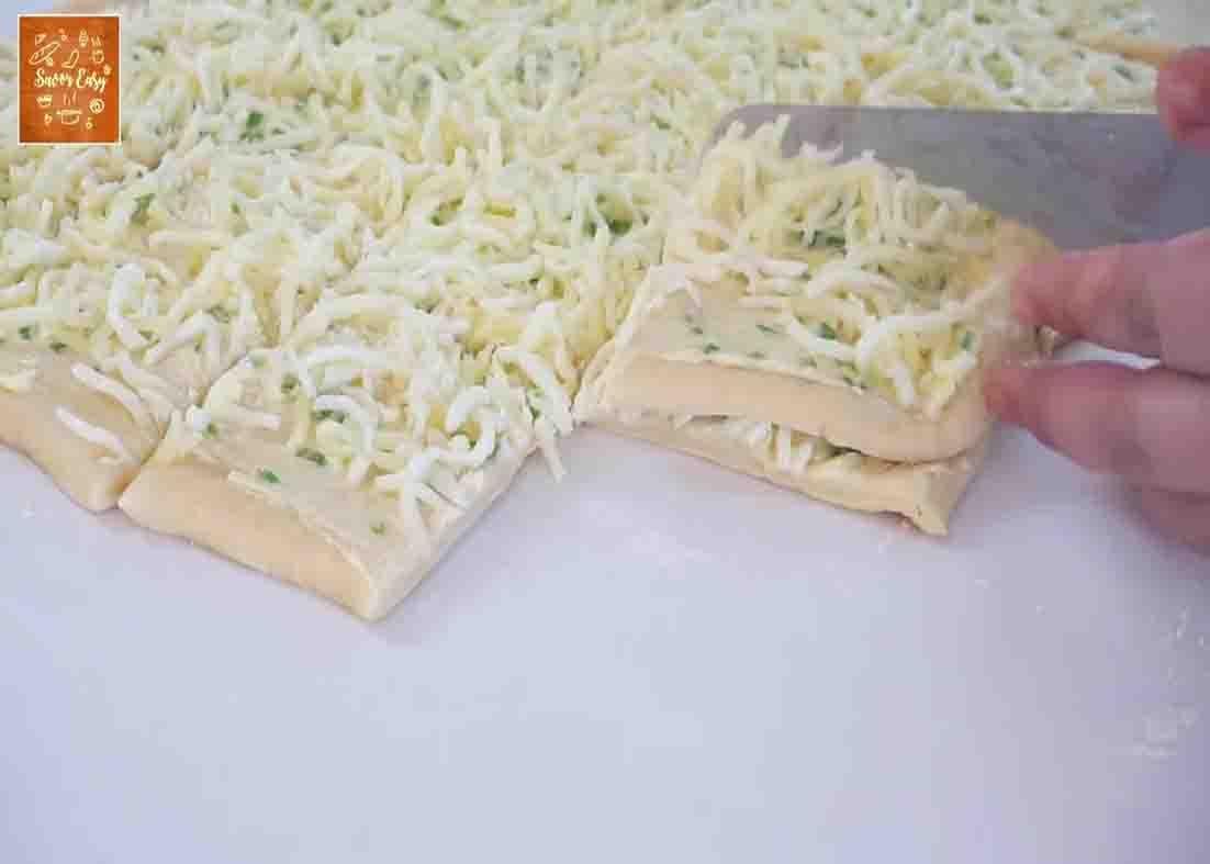 Stacking the dough pieces for the garlic and scallions bread