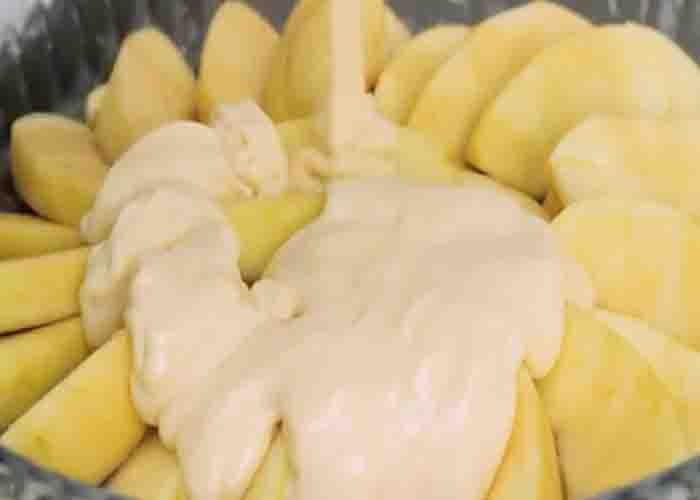 Adding the cake batter on top of the apples