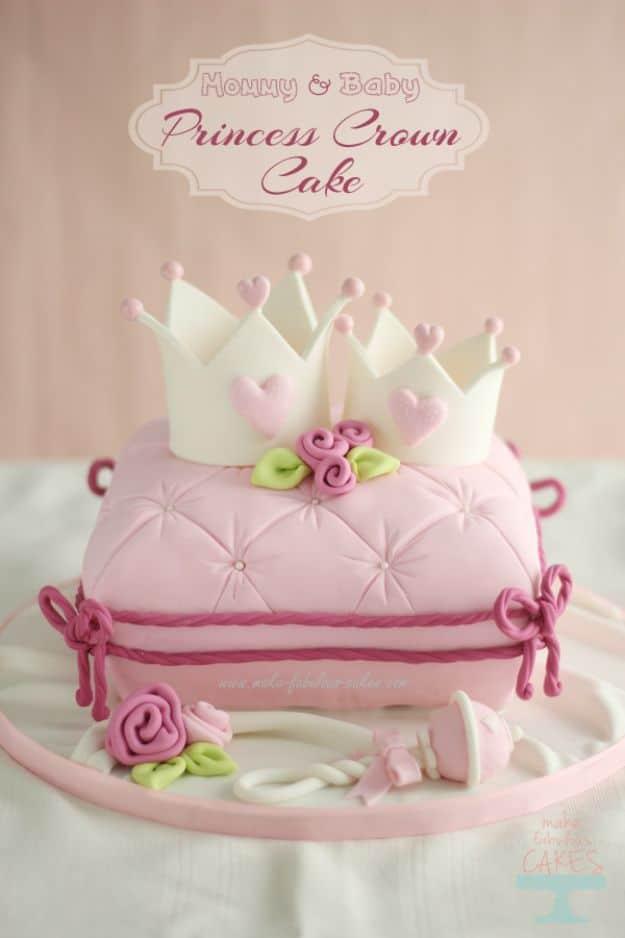 Pink quilted fondant pillow cake with tassels and sugar roses topped by two white fondant princess crowns