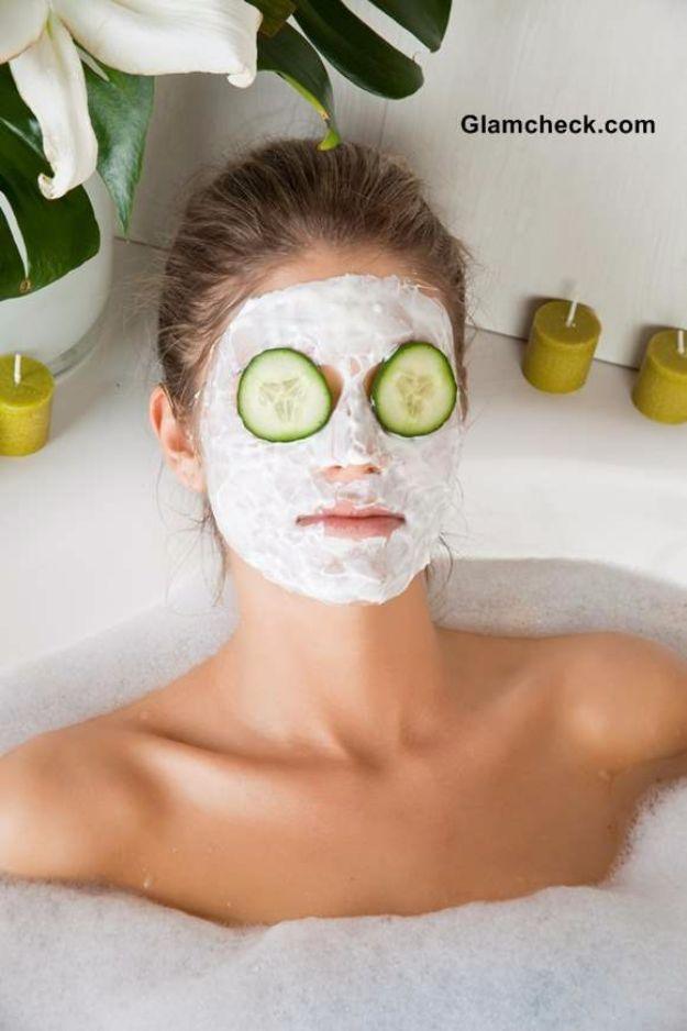 Cucumber face mask, a woman lying in a bubble bath with a white face mask on and cucumber slices over her eyes