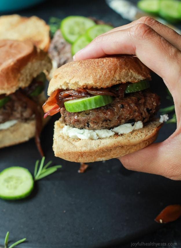 Grilled lamb burgers on toasted slider buns with whipped feta, cucumber slices and caramelized onion