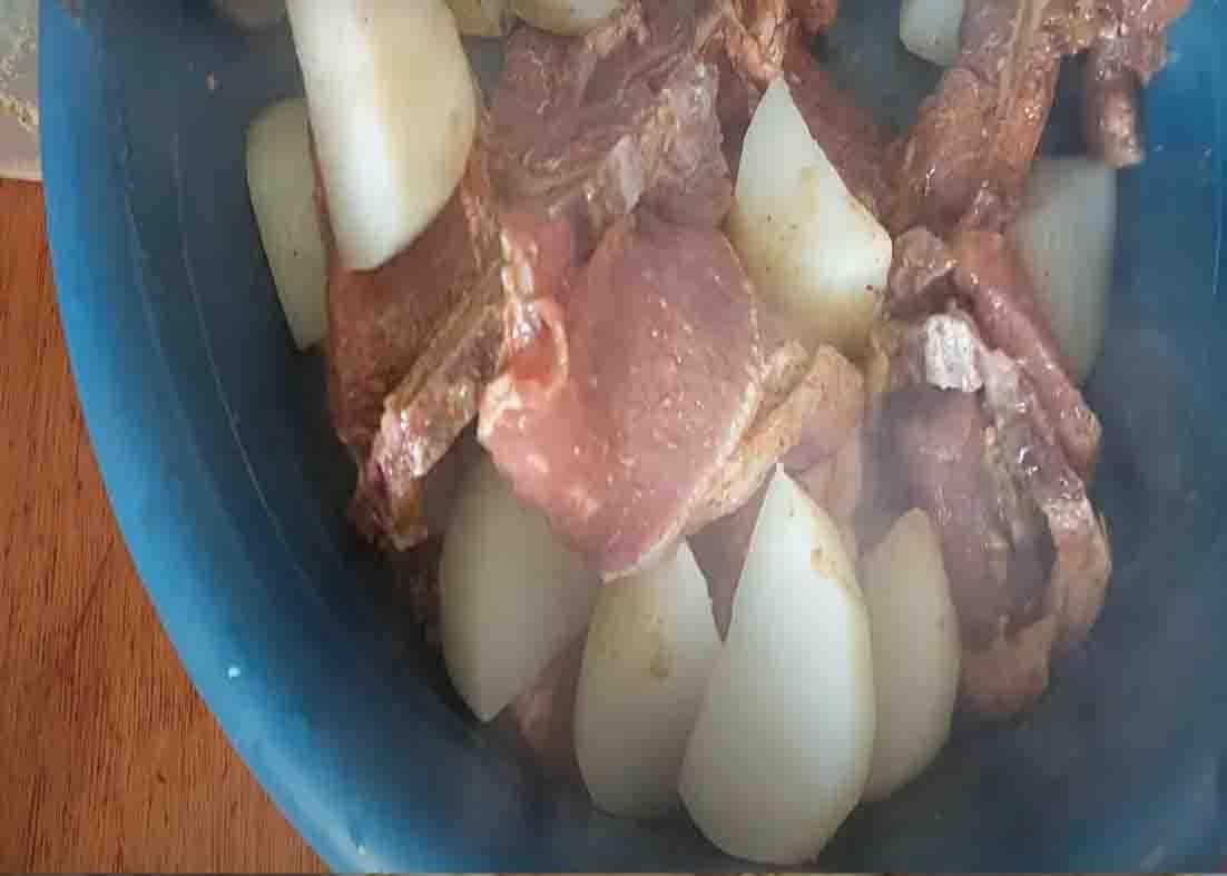 Mixing the pork and potatoes with the spices