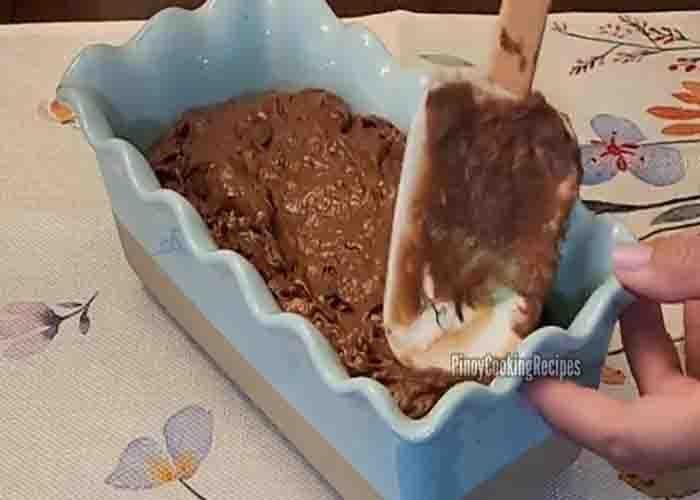Transferring the chocolate banana loaf batter in the loaf pan
