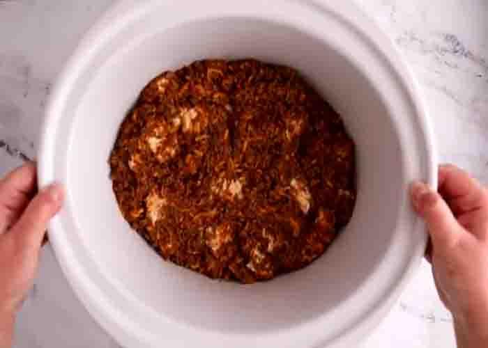 Adding the ground beef mixture to the slow cooker