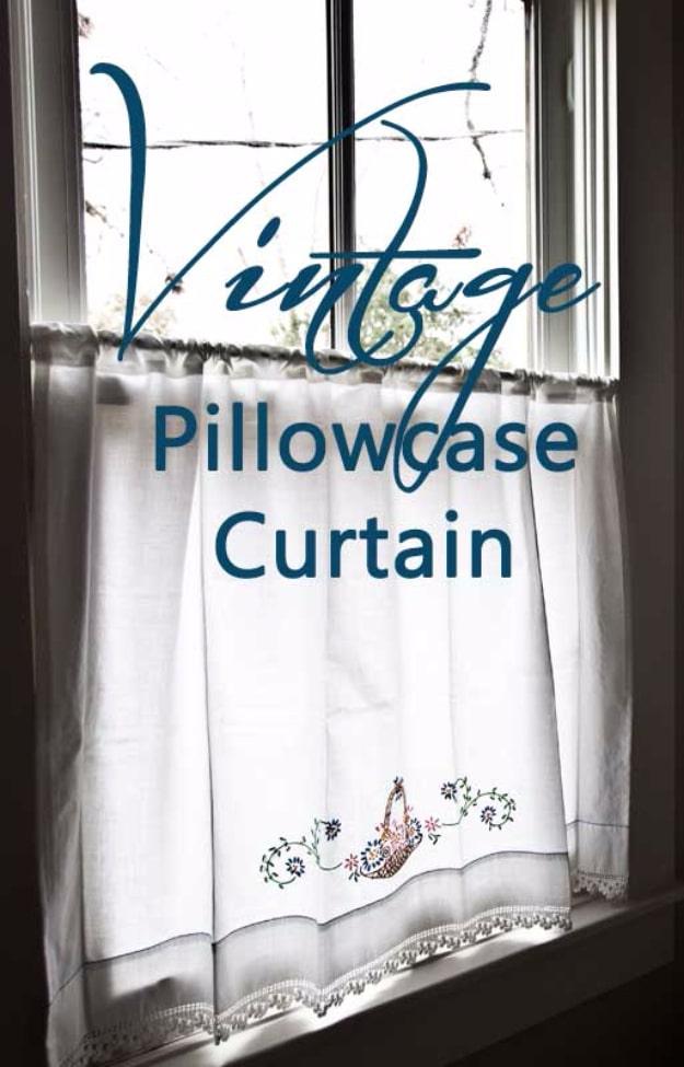 Typeset graphic reading Vintage Pillowcase Curtain over a photo of an embroidered white cafe curtain at a window