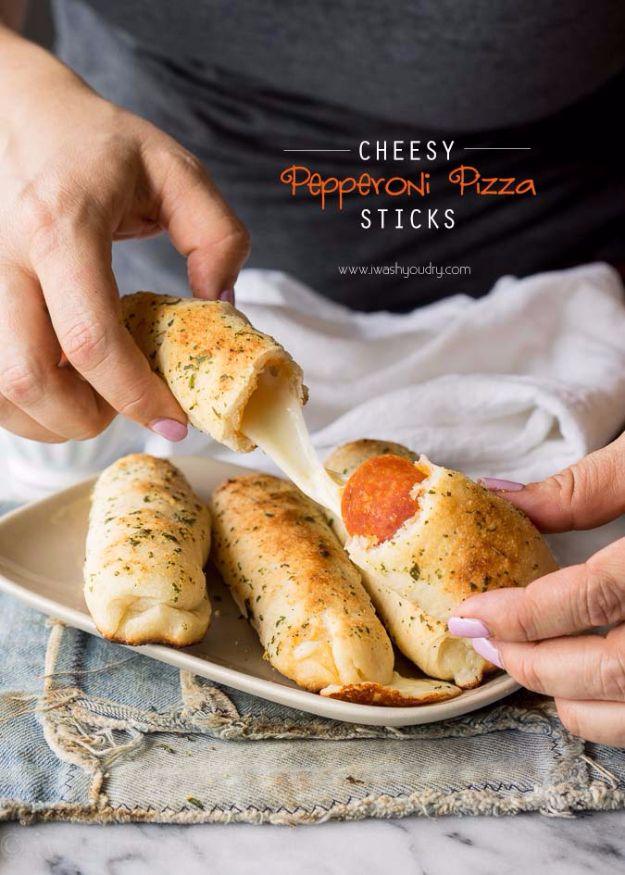 Cheesy pepperoni pizza sticks pulled apart with melted mozzarella, served with warm marinara for dipping
