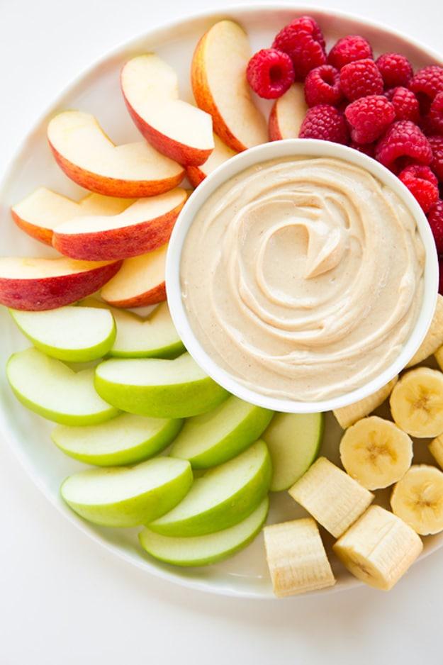 Peanut butter fruit dip in a bowl with sliced apples and strawberries, a quick last minute dessert idea