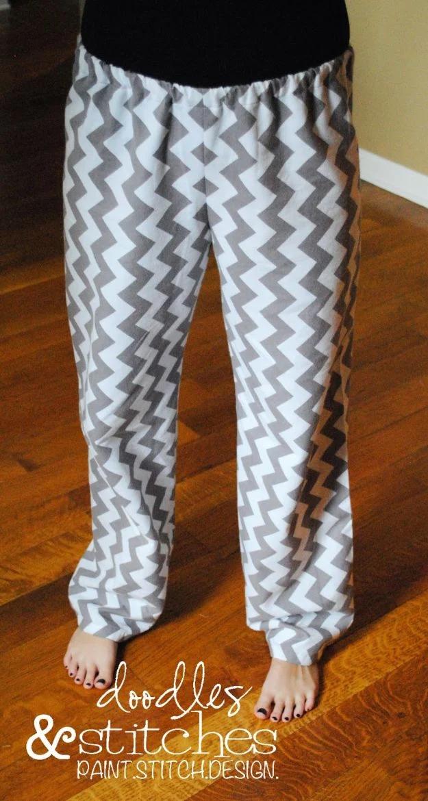 Child wearing gray and white chevron print flannel pajama pants, standing barefoot on a wooden floor