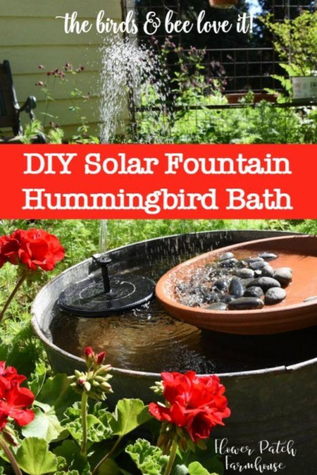 DIY Solar Fountain Hummingbird Bath graphic with a galvanized tub, terracotta dish of stones and geraniums