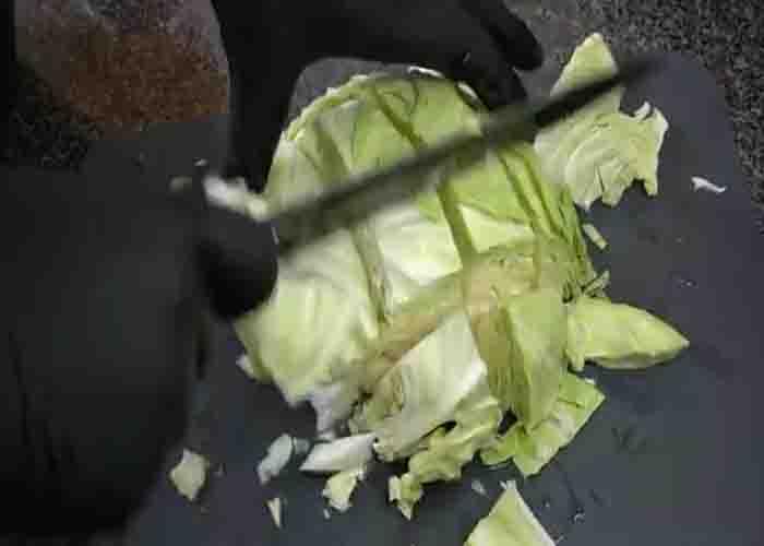 Chopping the cabbage for the smothered cabbage and ground beef recipe