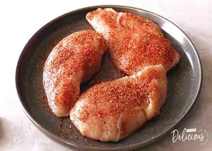 Seasoning the chicken for the foil packet recipe