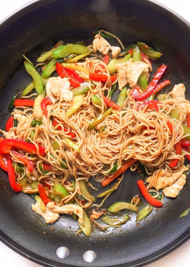 Healthy chicken lo mein with shirataki noodles, celery, chicken strips and vegetables in a hot wok ready to serve at home